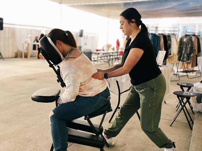NHI Clovis Graduate Alexis Lujan providing Chair Massage at an event