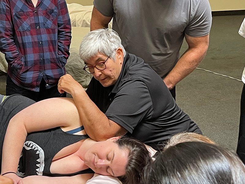 Cynthia Ribeiro provides an interactive neuromuscular therapy bodywork demonstration for a CE massage class